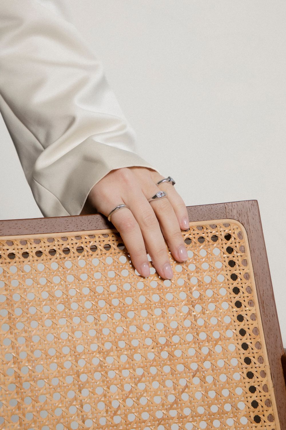 Hand with rings on a textured surface